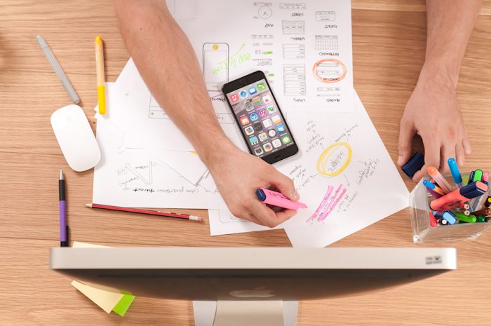Maquettes, croquis d'interface et notes sur un bureau